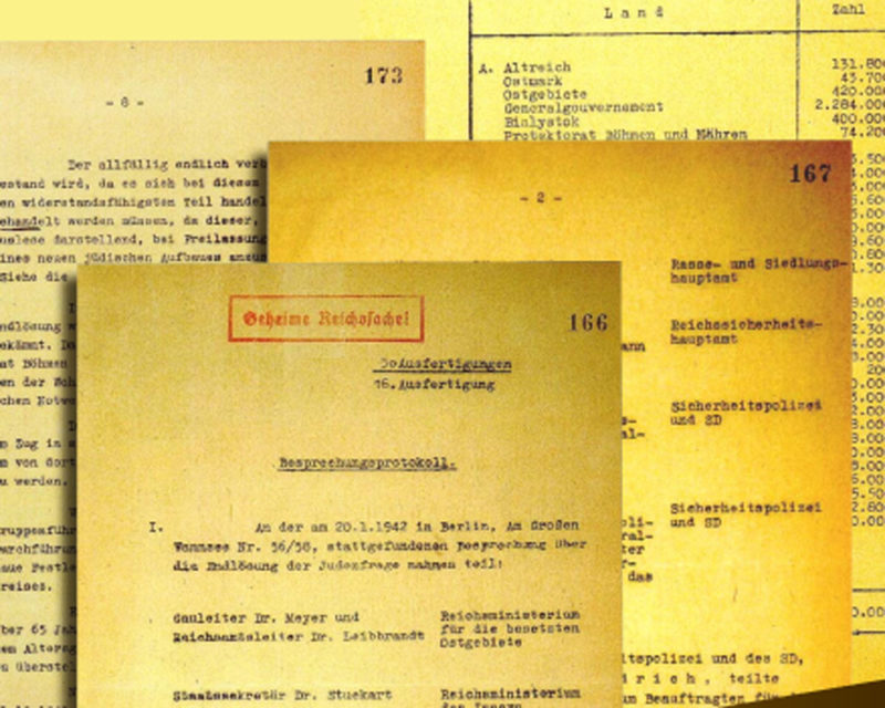 A close-up view of historical documents related to the Wannsee Conference, featuring typed pages and varying formats, highlighting the bureaucratic nature of the decisions made during the Holocaust.